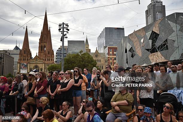 Members of the public attend a vigil in memory of victims who were mown down by a 26-year-old man driving a car, at Federation Square in Melbourne on...