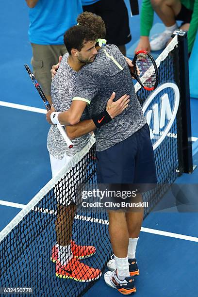 Grigor Dimitrov of Bulgaria congratulates Denis Istomin after their fourth round match on day eight of the 2017 Australian Open at Melbourne Park on...