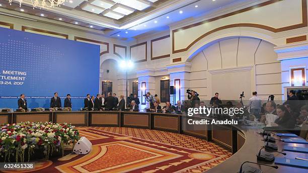 Representatives from the Syrian government and the opposition delegation take part in the first session of Syria peace talks in Astana, Kazakhstan on...