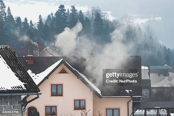 Dirty smoke comes out of the chimney as a lot of people still continue using coal and other harmful materials to heat homes. Air pollution in Poland...