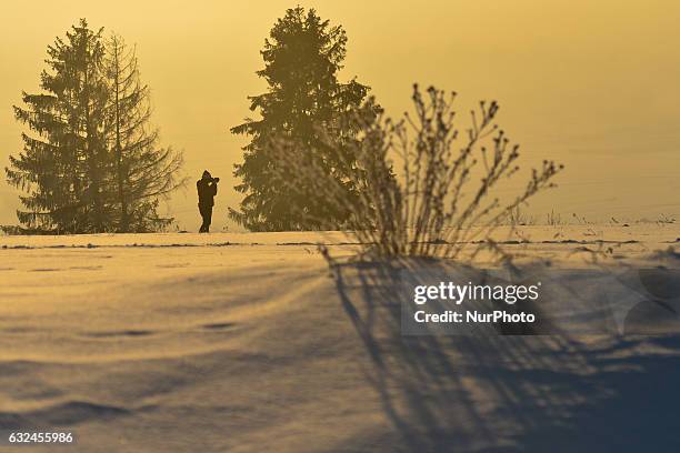 Person photographing a winter view of mountains near Kilkuszowa, on Zakopianka road between Nowy Targ and Rabka. On Sunday, 22 January 2017, in...