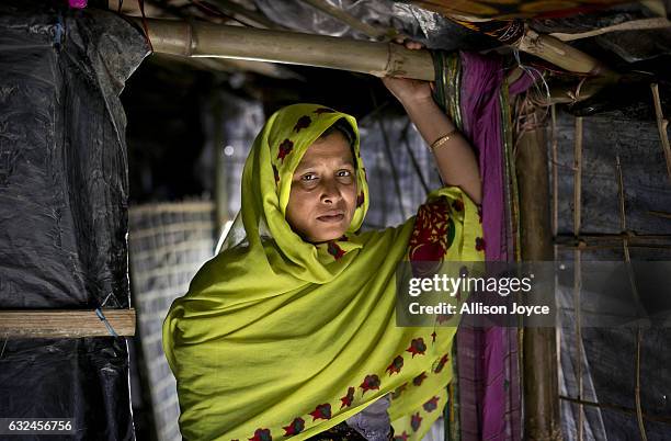 Nojiba poses for a photo in her makeshift house that she shares with 14 other refugees on January 20, 2017 in Kutalong Rohingya refugee camp in Cox's...