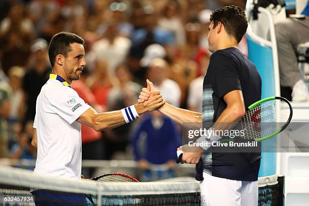 Roberto Bautista Agut of Spain congratulates Milos Raonic of Canada after their fourth round match on day eight of the 2017 Australian Open at...