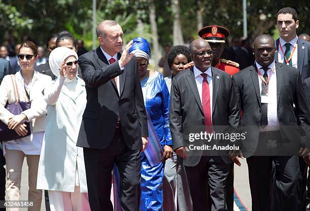 Turkish President Recep Tayyip Erdogan and his wife Emine Erdogan wave to Tanzanian people during an official welcoming ceremony in Dar Es Salaam,...
