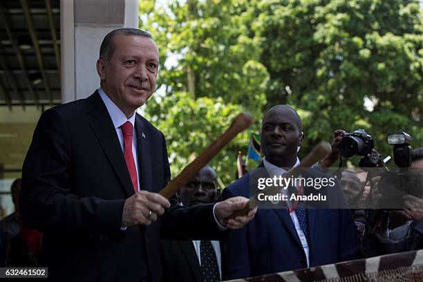 President of Turkey Recep Tayyip Erdogan plays a traditional drum during an official welcoming ceremony in Dar es Salaam, Tanzania on January 23,...