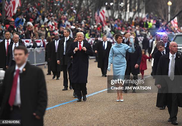 President Donald Trump and First Lady Melania walk the inaugural parade route on Pennsylvania Avenue in Washington, DC, on January 20, 2017 following...