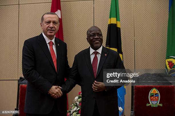 Turkish President Recep Tayyip Erdogan and Tanzanian President John Pombe Joseph Magufuli shake hands as they pose for a photo after their press...