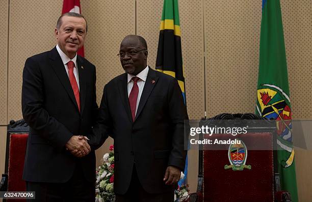 Turkish President Recep Tayyip Erdogan and Tanzanian President John Pombe Joseph Magufuli shake hands as they pose for a photo after their press...