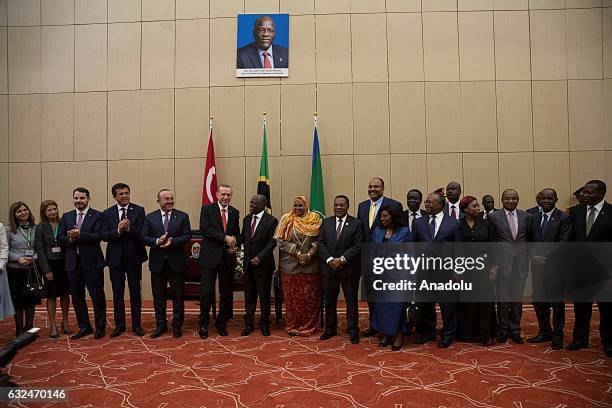 Turkish President Recep Tayyip Erdogan and Tanzanian President John Pombe Joseph Magufuli shake hands as they pose for a photo after their press...