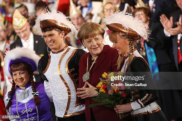 German Chancellor Angela Merkel poses with Carnival performers during the annual Carnival reception at the Chancellery on January 23, 2017 in Berlin,...