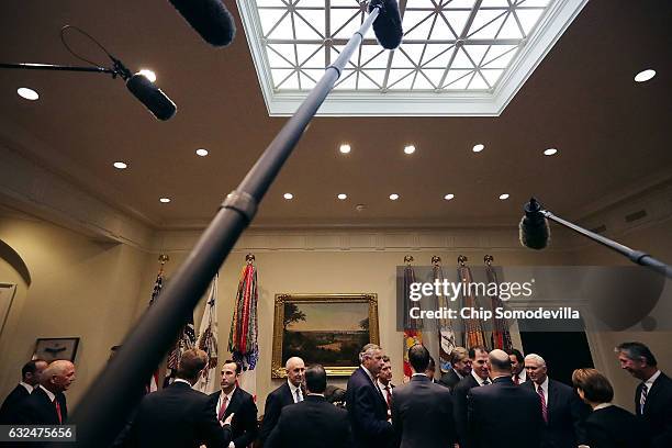 Business executives and members of the Trump Administration, including Vice President Mike Pence, wait for the arrival of President Donald Trump...