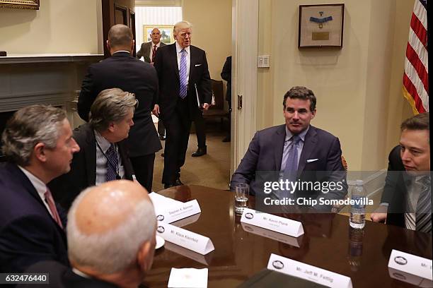 President Donald Trump walks into the Roosevelt Room for a meeting with Mark Sutton of International Paper, Jeff Fettig of Whirlpool, White House...