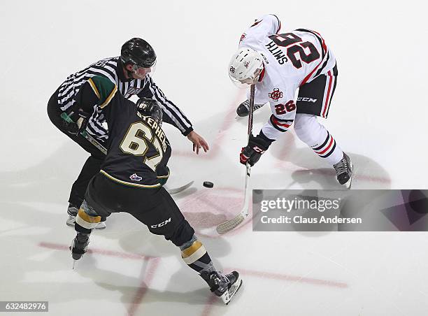 Mitchell Stephens of the London Knights takes a faceoff against Ryan Smith of the Niagara IceDogs during an OHL game at Budweiser Gardens on January...