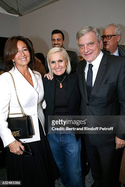Stylist Maria Grazia Chiuri standing between CEO Dior Sidney Toledano and his wife Katia pose backstage after the Christian Dior Spring Summer 2017...