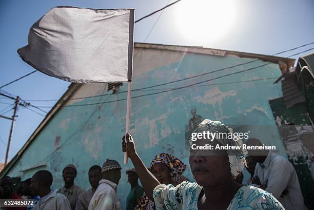 Woman cheers as ECOWAS troops from Senegal gather outside the Gambian statehouse on January 23, 2017 in Banjul, The Gambia. ECOWAS is in Gambia to...