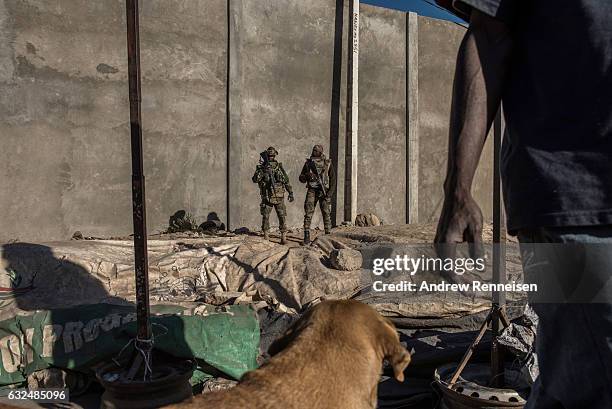 Troops stand watch at a market on January 23, 2017 in Banjul, The Gambia. ECOWAS is in Gambia to ensure a safe transition of power after...