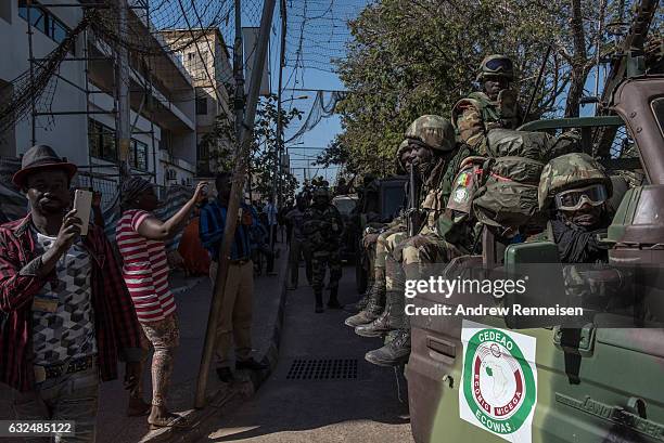 Troops from Senegal move towards the Gambian statehouse on January 23, 2017 in Banjul, The Gambia. ECOWAS is in Gambia to ensure a safe transition of...