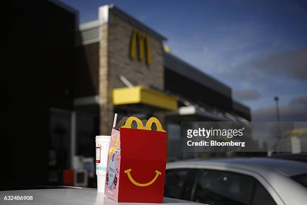 Happy Meal box sits on top of a customer's vehicle outside a McDonald's Corp. Fast food restaurant in White House, Tennessee, U.S., on Wednesday,...