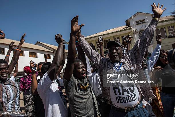 People celebrate as ECOWAS troops from Senegal gather outside the Gambian statehouse on January 23, 2017 in Banjul, The Gambia. ECOWAS is in Gambia...