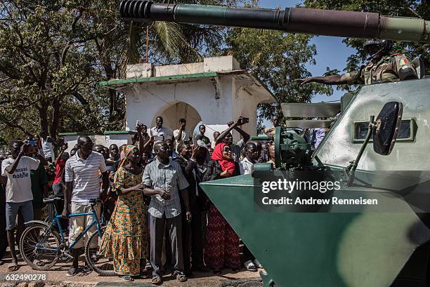 People cheer as ECOWAS troops from Senegal gather outside the Gambian statehouse on January 23, 2017 in Banjul, The Gambia. ECOWAS is in Gambia to...