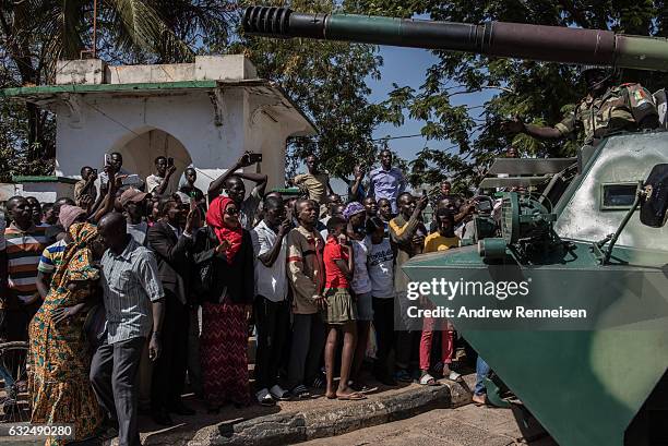 People cheer as ECOWAS troops from Senegal gather outside the Gambian statehouse on January 23, 2017 in Banjul, The Gambia. ECOWAS is in Gambia to...
