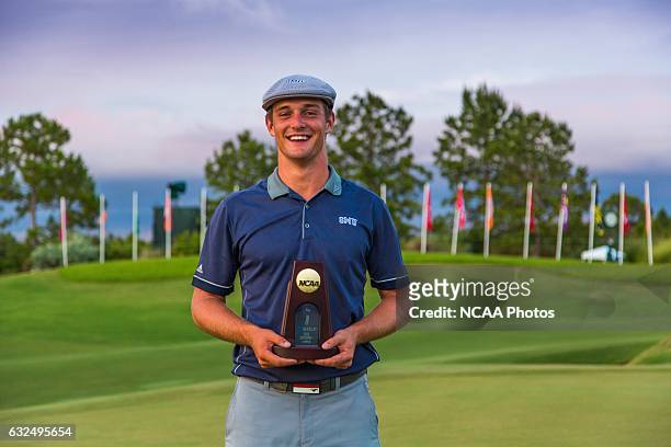 Bryson Dechambeau of Southern Methodist University holds his trophy on the 18th green of the Concession Golf Club in Bradenton, Florida after winning...