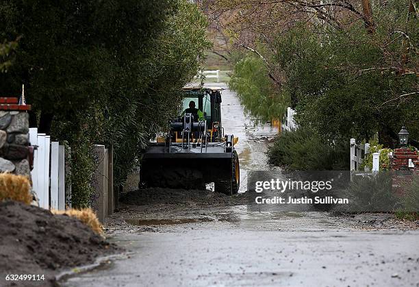 Front loader clears mud and debris from a street during a rain storm on January 23, 2017 in Santa Clarita, California. Heavy rains pounded Southern...