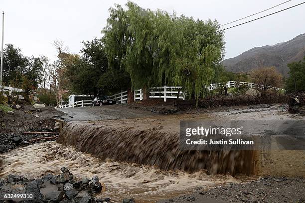 Floodwaters flow over a street during a rain storm on January 23, 2017 in Santa Clarita, California. Heavy rains pounded Southern California over the...