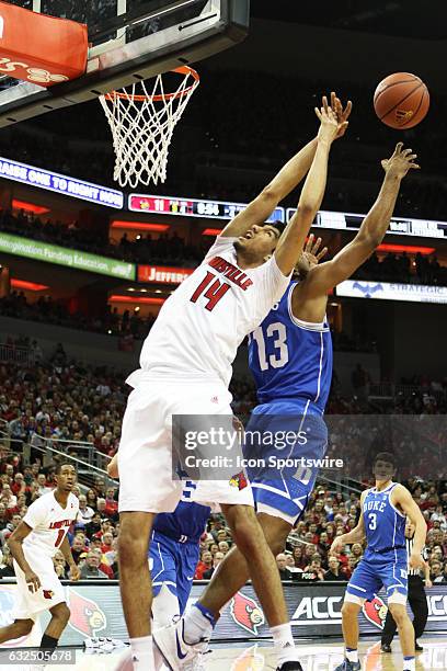 Louisville Cardinals forward Anas Mahmoud and Duke Blue Devils guard Matt Jones fight for a loose ball in the air in the first half on January 14,...