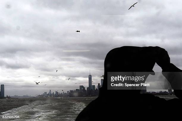 Person rides the Staten Island Ferry as Manhattan sits under heavy cloud cover as the city prepares for a nor'easter storm on January 23, 2017 in New...