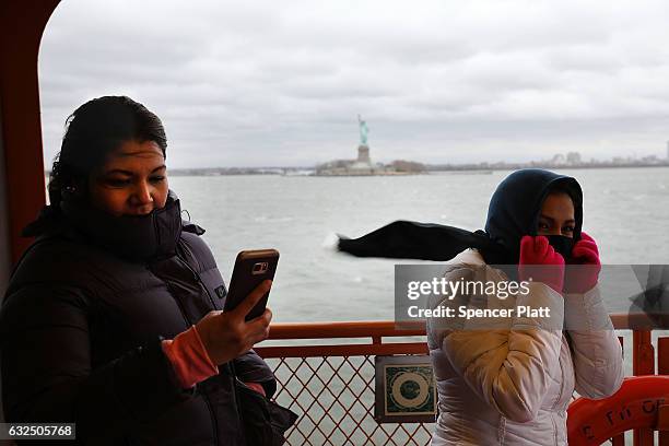 Passengers on the Staten Island Ferry struggle with the wind as New York City prepares for a nor'easter storm on January 23, 2017 in New York City....