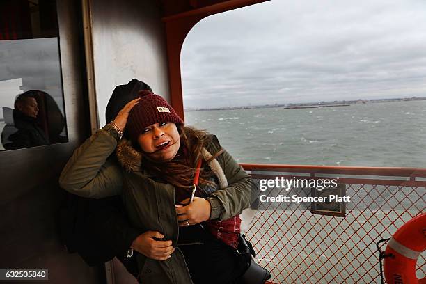 Passengers on the Staten Island Ferry struggle with the wind as New York City prepares for a nor'easter storm on January 23, 2017 in New York City....