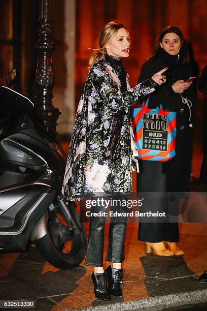 Olivia Palermo is wearing a floral print jacket, black leather pants, and black leather heels, after the Giambattista Valli show, during Paris...