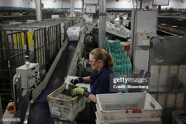 Worker sorts through periodicals at the United States Postal Service sorting center in Louisville, Kentucky, U.S., on Friday, Jan. 13, 2017. Starting...