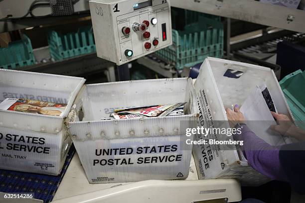 Worker sorts through periodicals at the United States Postal Service sorting center in Louisville, Kentucky, U.S., on Friday, Jan. 13, 2017. Starting...