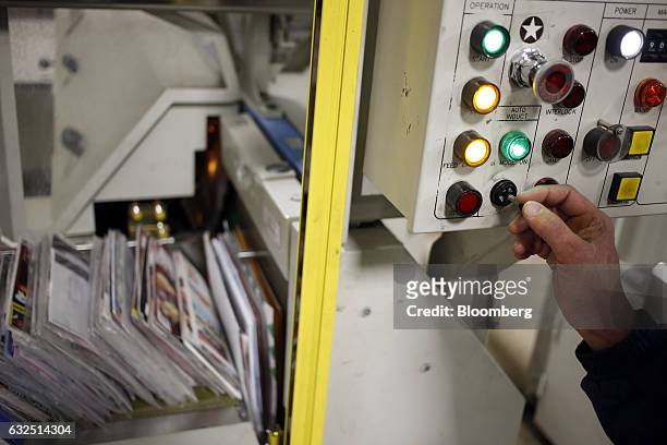 Worker demonstrates the use of an automated mail sorting machine at the United States Postal Service sorting center in Louisville, Kentucky, U.S., on...