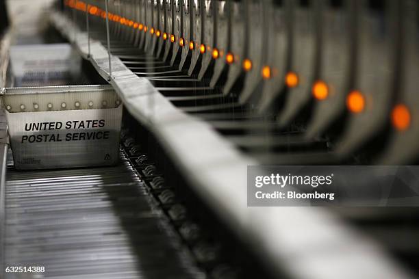 Mail tray moves along an automated sorting machine inside a United States Postal Service sorting center in Louisville, Kentucky, U.S., on Friday,...