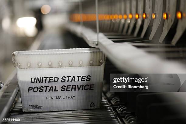 Mail tray moves along an automated sorting machine inside a United States Postal Service sorting center in Louisville, Kentucky, U.S., on Friday,...