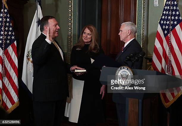 Mike Pompeo is sworn in as CIA Director by Vice President Mike Pence as wife Susan Pompeo looks on at Eisenhower Executive Office Building January...