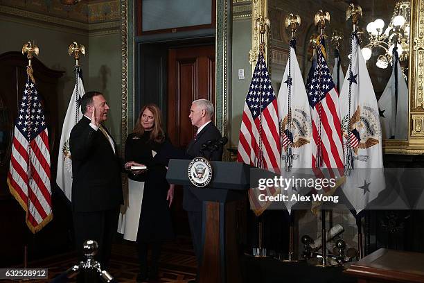 Mike Pompeo is sworn in as CIA Director by Vice President Mike Pence as wife Susan Pompeo looks on at Eisenhower Executive Office Building January...