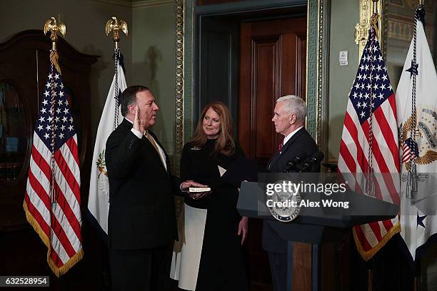 Mike Pompeo is sworn in as CIA Director by Vice President Mike Pence as wife Susan Pompeo looks on at Eisenhower Executive Office Building January...