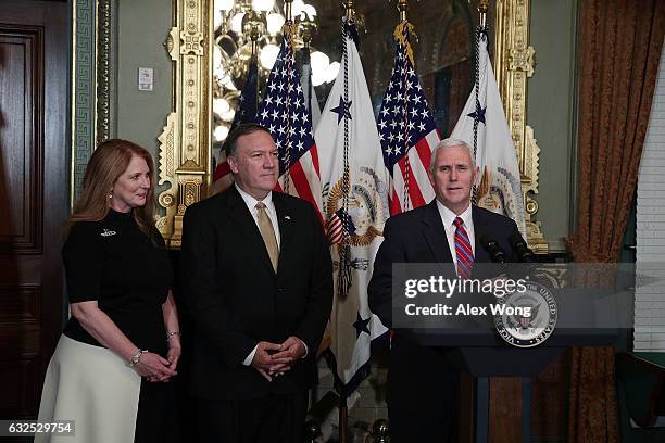 Vice President Mike Pence speaks as Mike Pompeo and wife Susan Pompeo look on during a swearing in ceremony for Pompeo to become CIA Director at...