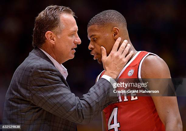 Head coach Mark Gottfried talks to Dennis Smith Jr. #4 of the North Carolina State Wolfpack during their win against the Duke Blue Devils at Cameron...