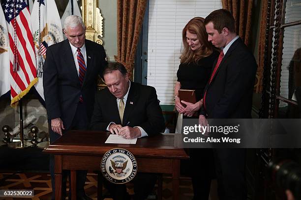 Mike Pompeo signs the affidavit of appointment as his wife Susan Pompeo , son Nick Pompeo , and U.S. Vice President Mike Pence look on during a...