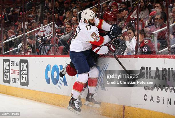 Derek MacKenzie of the Florida Panthers lays a body check onto Connor Murphy of the Arizona Coyotes during the first period of the NHL game at Gila...