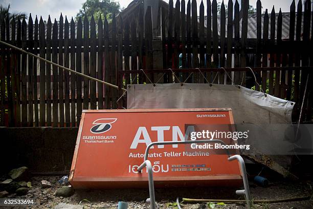 An abandoned sign for a Thanachart Bank Pcl automated teller machine sits near a parking lot in Koh Phangan, Surat Thani, Thailand, on Wednesday,...