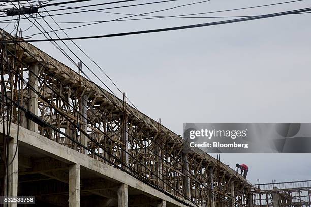 Worker stands on top of a building under construction in Koh Phangan, Surat Thani, Thailand, on Wednesday, Jan. 18, 2017. Government spending and...