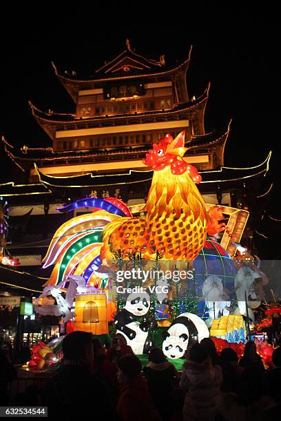 Tourists take photos of a lantern of rooster at a lantern show in Yu Garden on January 22, 2017 in Shanghai, China. To welcome the Year of Rooster,...