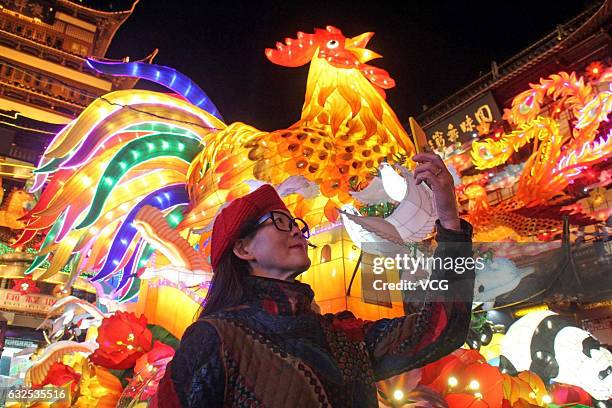 Tourists take photos of a lantern of rooster at a lantern show in Yu Garden on January 22, 2017 in Shanghai, China. To welcome the Year of Rooster,...