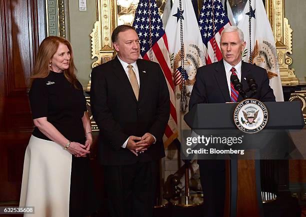 Vice President Mike Pence, right, speaks before administering the oath of office to Representative Mike Pompeo, a Republican from Kansas, center, as...